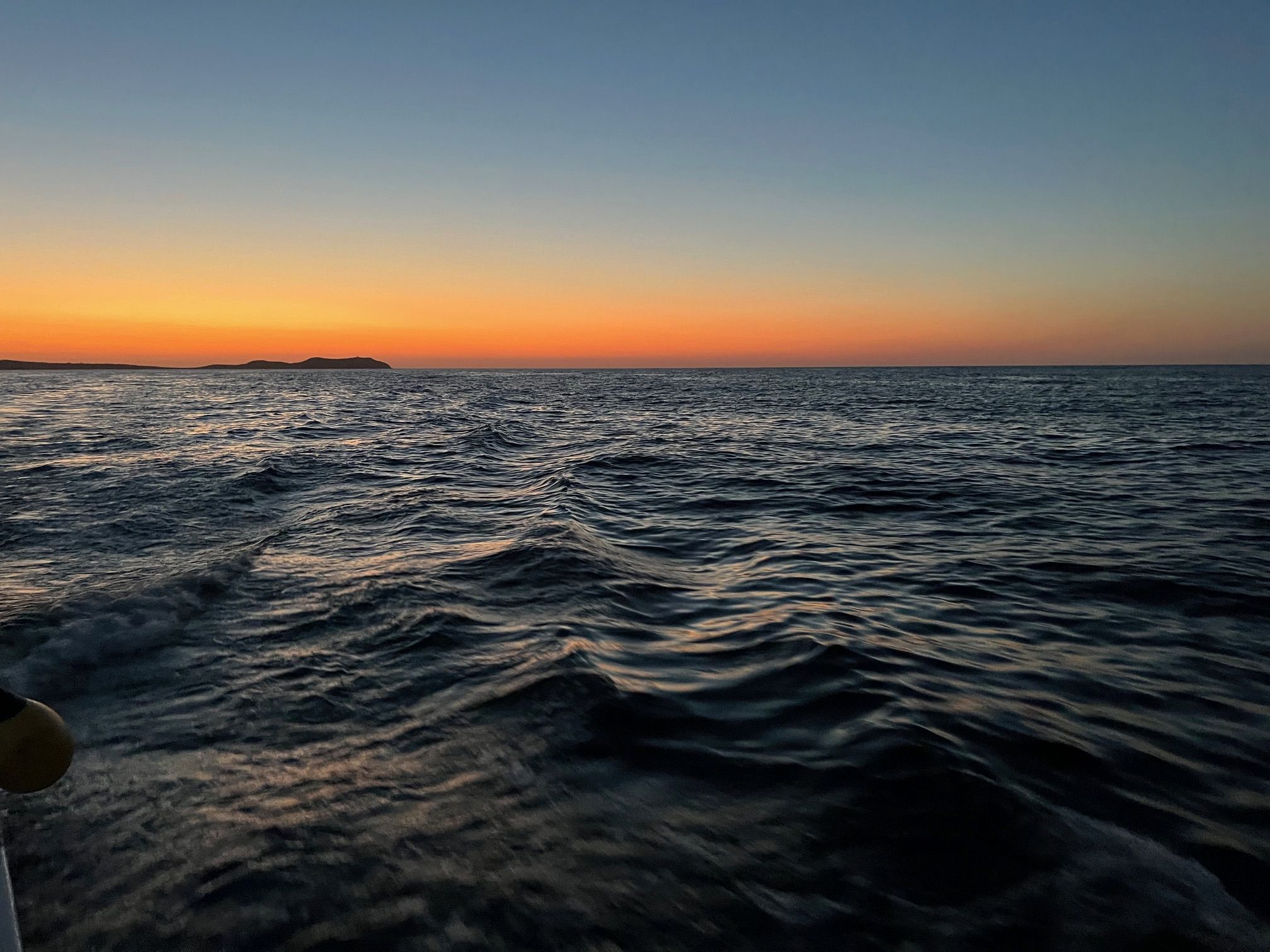 Imagen de la puesta de sol sobre la Reserva Natural de Conejera durante una excursión en barco de Meet the Sea en el contexto de una inmersión corporativa